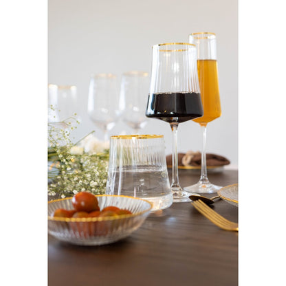 Wine glasses with gold rims on a table with a blurred background