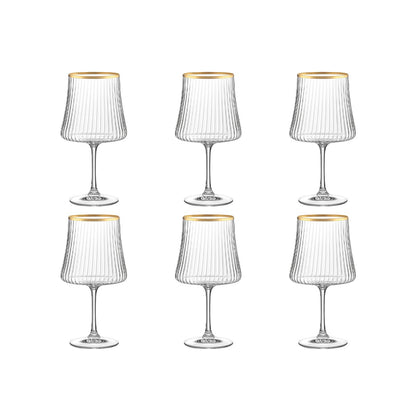 Set of six clear wine glasses with gold rims on a white background
