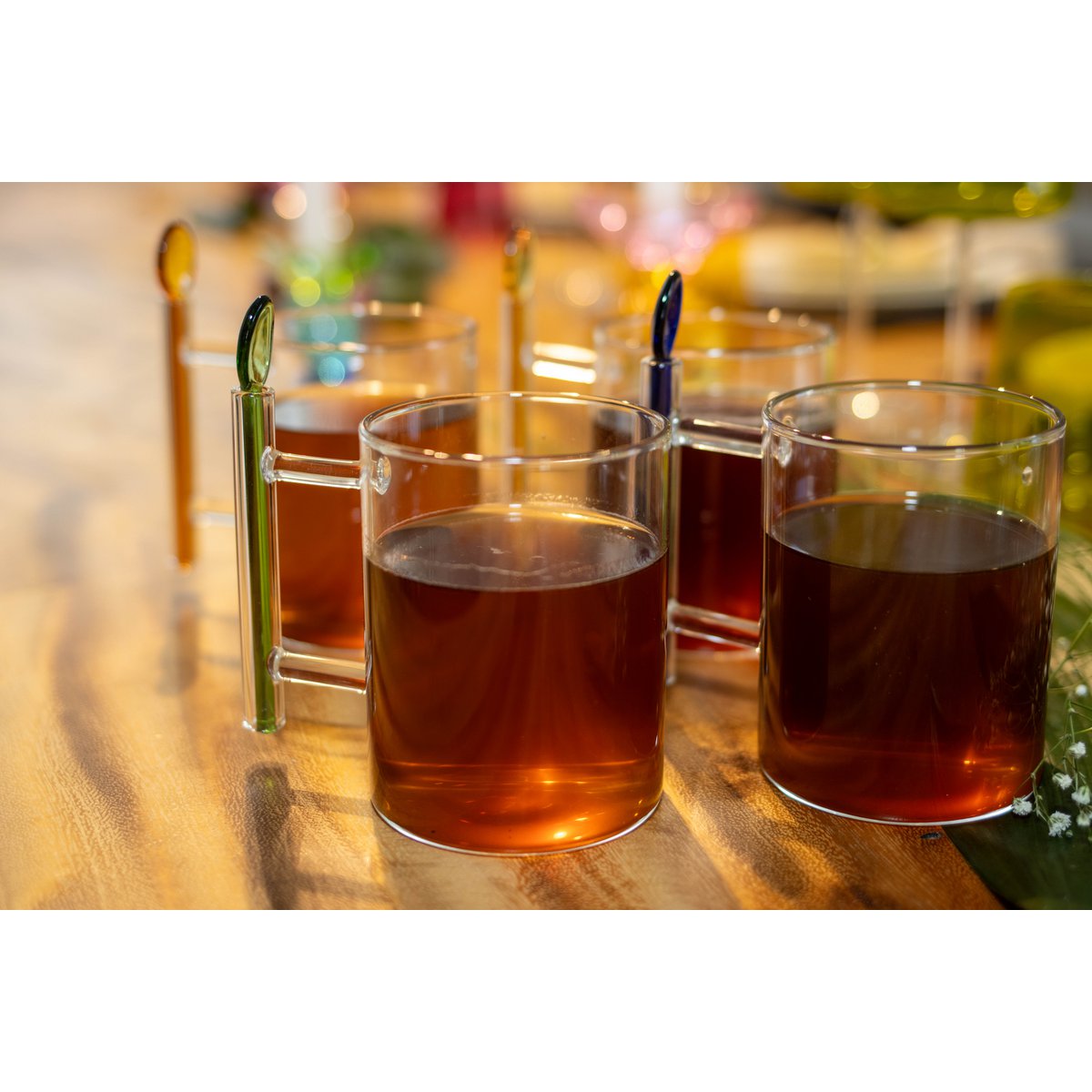 Glass cups with amber liquid on a wooden surface