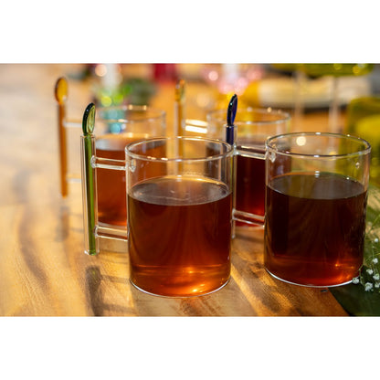 Glass cups with amber liquid on a wooden surface